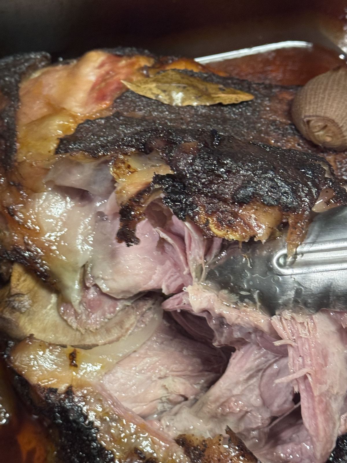 Slow-braised carnitas being pulled by hand