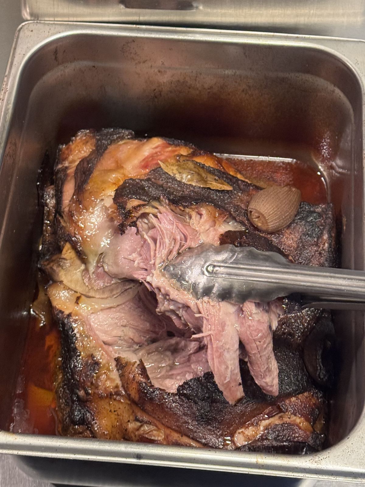 Tender carnitas being prepared in the kitchen