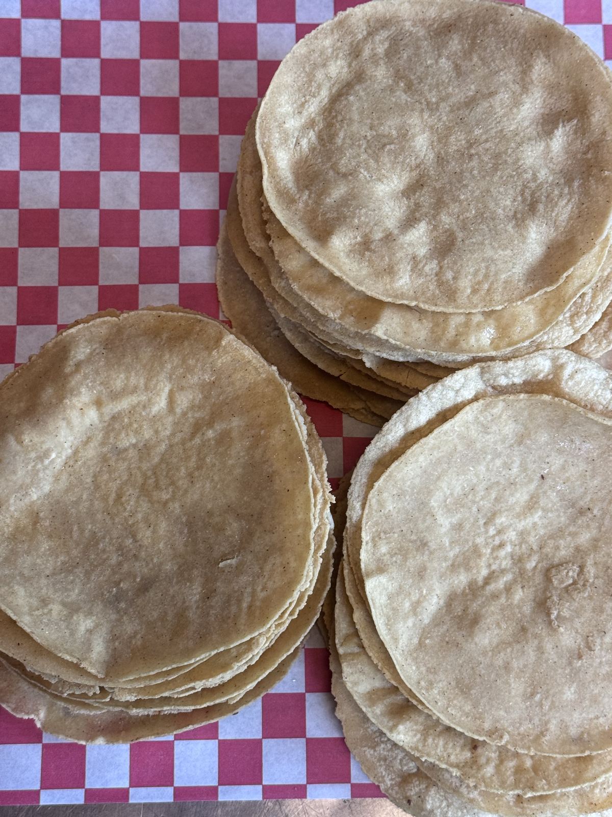 Fresh handmade tortillas stacked on the counter