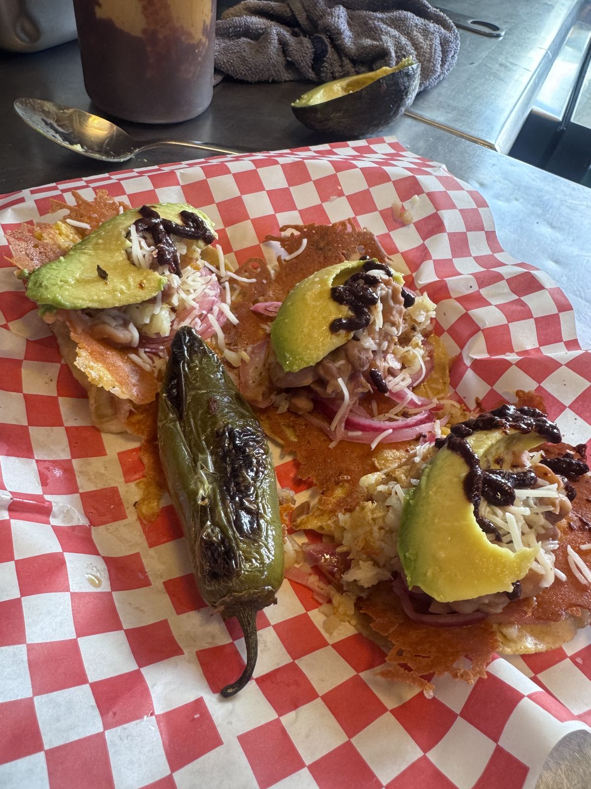 Finished tacos with avocado, pickled onions and grilled jalapeño