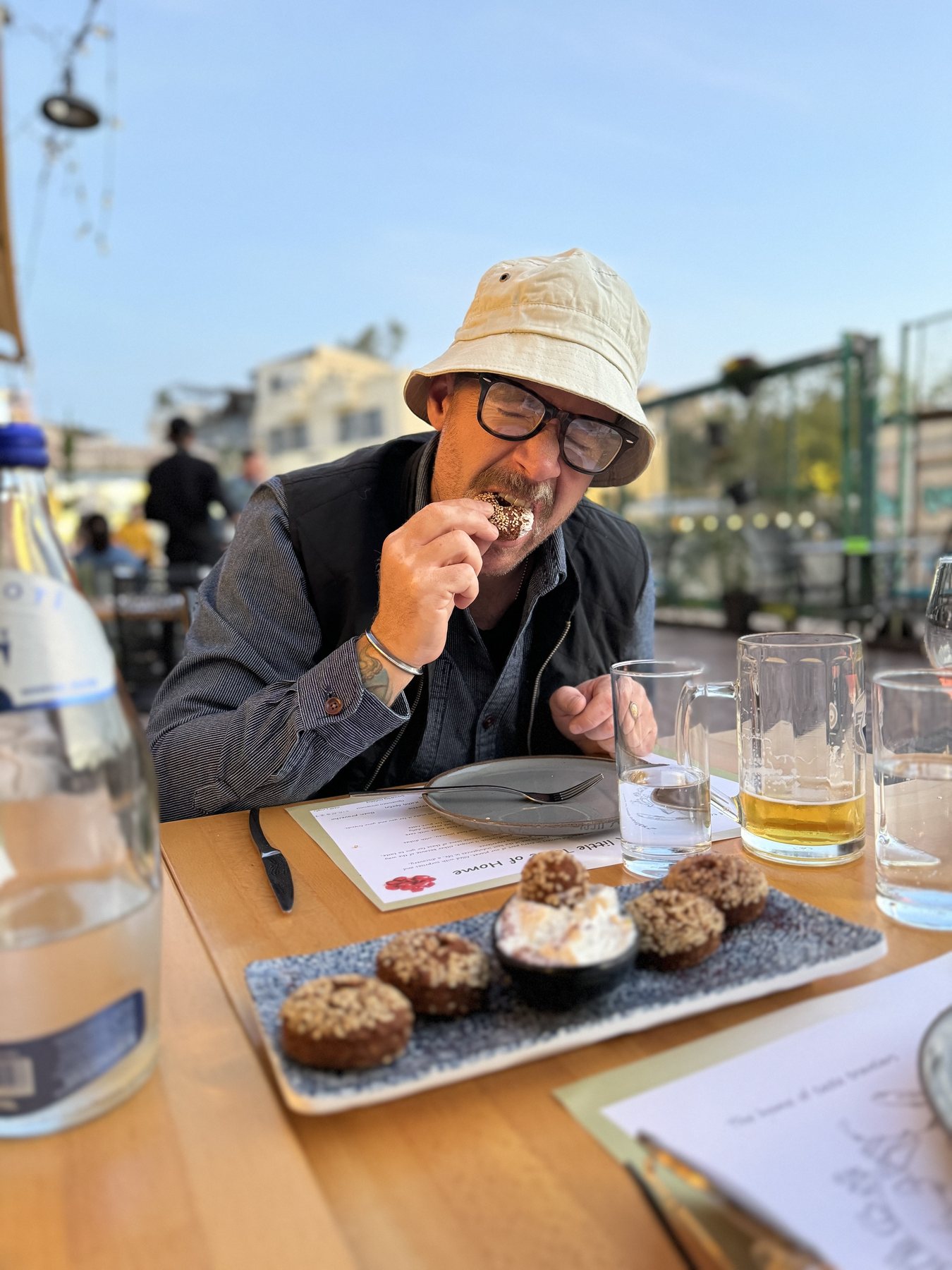 Cody tasting a dish at an outdoor restaurant